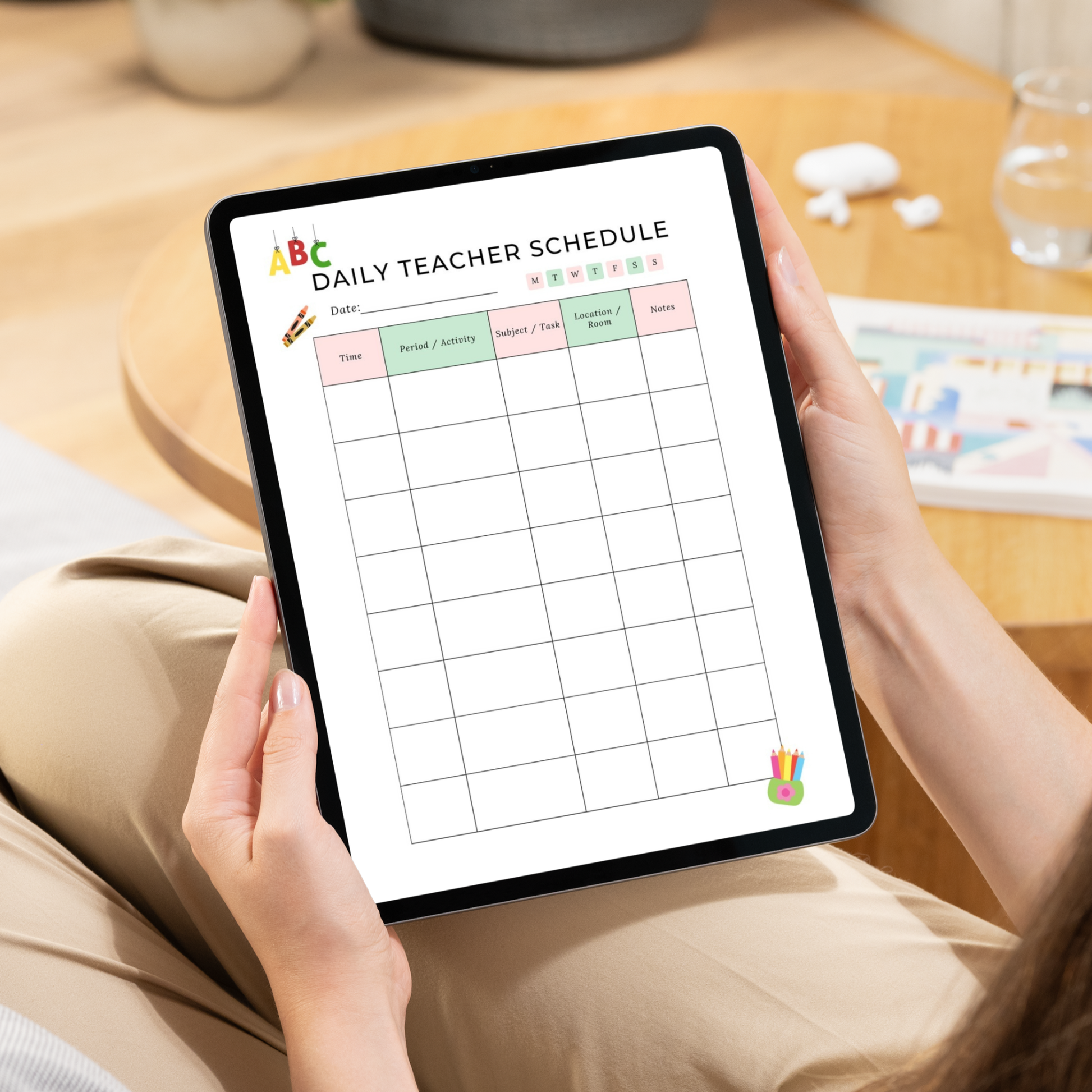 A person holding a tablet displaying a printable daily teacher schedule planner. The planner has pastel-colored headers for period, activity, subject, frequency, and homework, with a grid below.