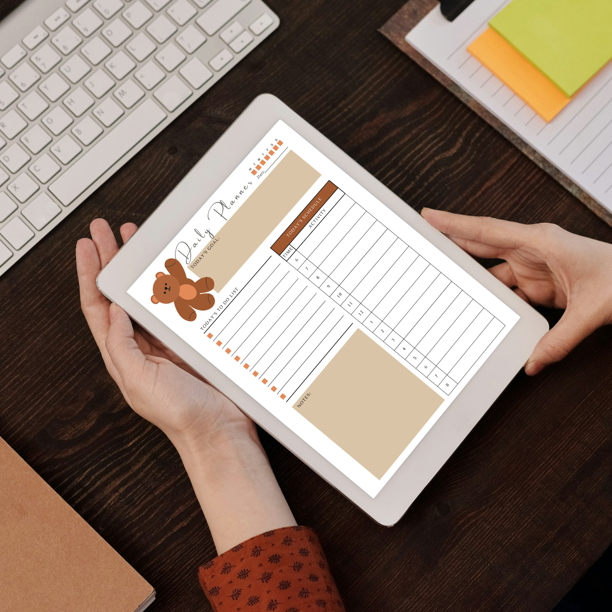 Undated digital teddy bear daily and weekly planner PDF bundle shown side by side on two iPads with a warm cozy design in brown tan and beige tones featuring an illustrated teddy bear accent, the daily planner featuring a day of week tracker, date field, today's goal section, to do list with checkboxes, time and activity hourly schedule from 6AM to 8PM and a notes section, and the weekly planner featuring this week's goal section, to do list with checkboxes, Monday through Sunday weekly schedule columns.