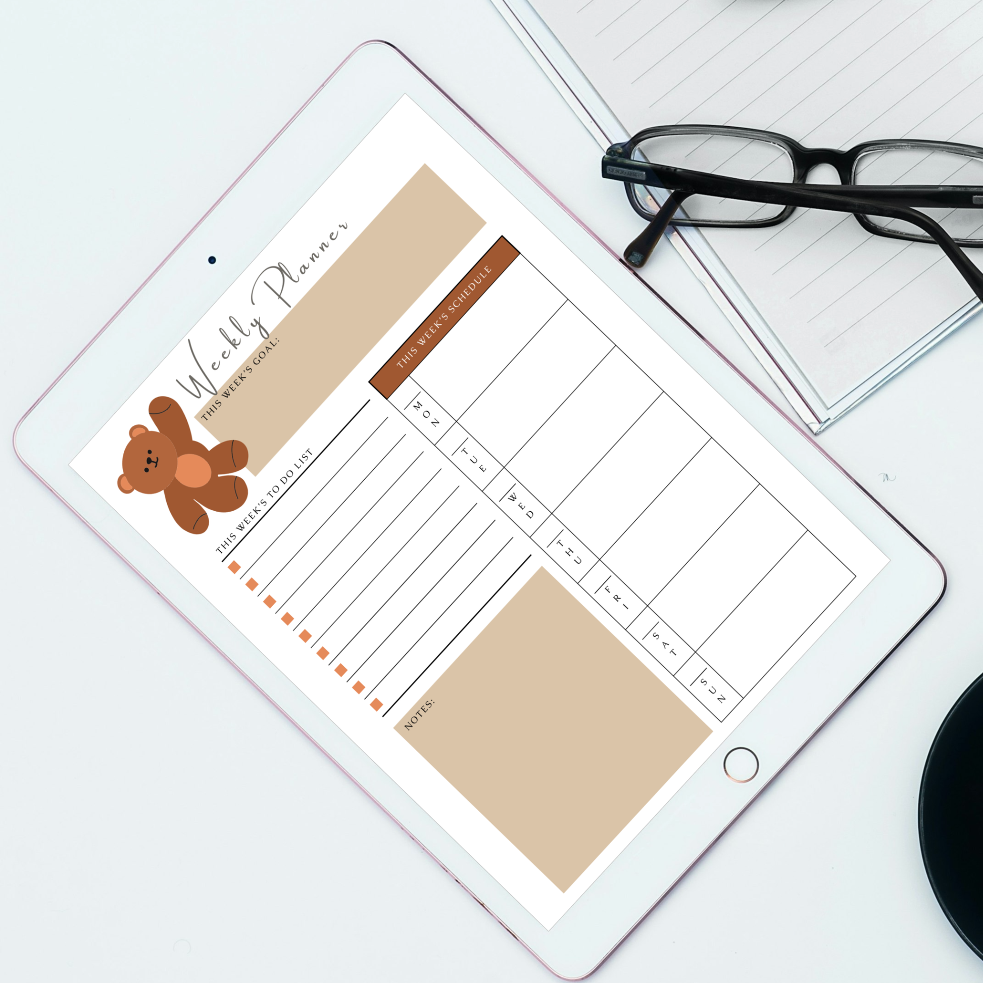 Undated digital teddy bear daily and weekly planner PDF bundle shown side by side on two iPads with a warm cozy design in brown tan and beige tones featuring an illustrated teddy bear accent, the daily planner featuring a day of week tracker, date field, today's goal section, to do list with checkboxes, time and activity hourly schedule from 6AM to 8PM and a notes section, and the weekly planner featuring this week's goal section, to do list with checkboxes, Monday through Sunday weekly schedule columns.